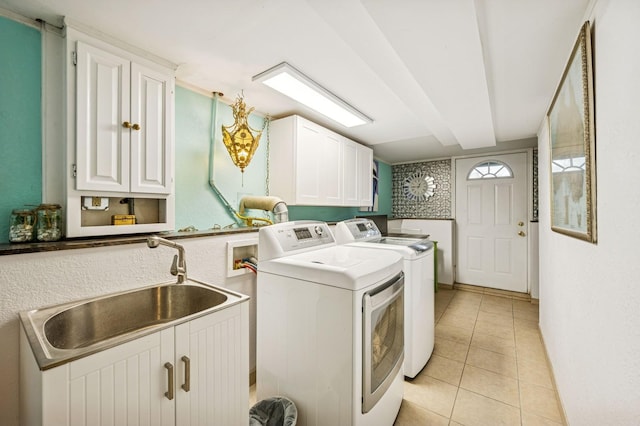 2500 Ensign Ave N, Golden Valley, MN 55427 - laundry area featuring washer and dryer, cabinet space, and light tile patterned flooring