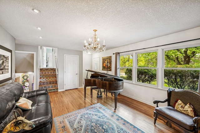2500 Ensign Ave N, Golden Valley, MN 55427 - living area with a textured ceiling, light wood-style flooring, a chandelier, stairs, and recessed lighting