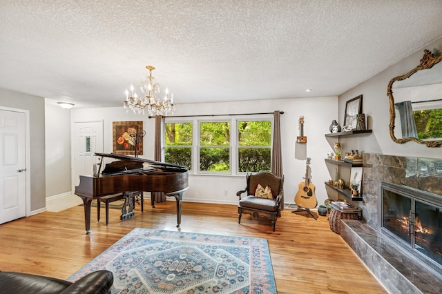 2500 Ensign Ave N, Golden Valley, MN 55427 - sitting room featuring light wood finished floors, a textured ceiling, a chandelier, and a high end fireplace