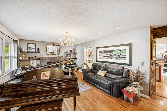 2500 Ensign Ave N, Golden Valley, MN 55427 - living area featuring light wood-type flooring, a chandelier, a textured ceiling, a fireplace, and recessed lighting