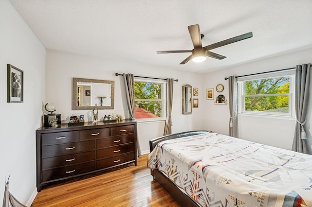2500 Ensign Ave N, Golden Valley, MN 55427 - bedroom featuring multiple windows, light wood-style floors, and ceiling fan