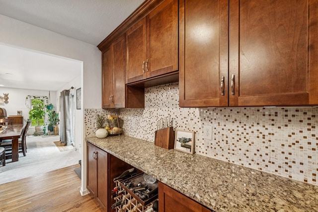 2500 Ensign Ave N, Golden Valley, MN 55427 - kitchen with tasteful backsplash, light stone counters, and light wood-style floors