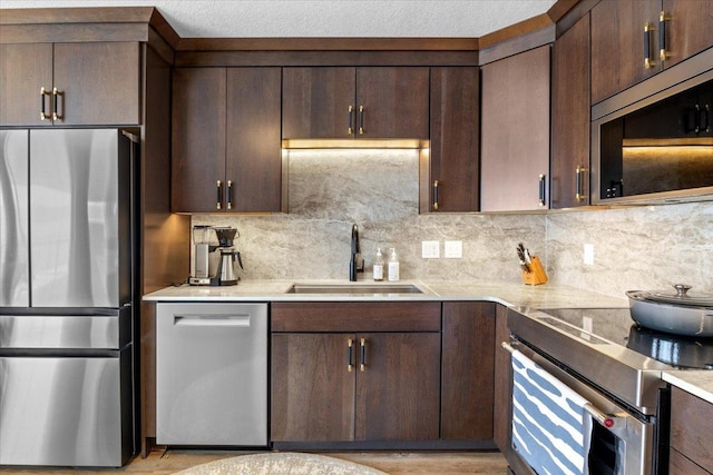 1702 Lakeshore Dr Unit 3, Lake City, MN 55041 - kitchen with appliances with stainless steel finishes, light countertops, dark brown cabinets, and decorative backsplash