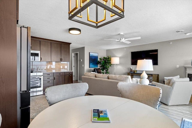 1702 Lakeshore Dr Unit 3, Lake City, MN 55041 - dining area with ceiling fan, a textured ceiling, and light wood-style floors