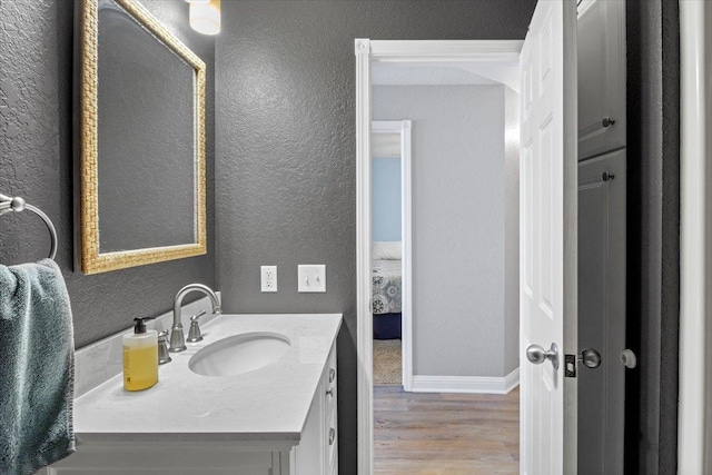 1702 Lakeshore Dr Unit 3, Lake City, MN 55041 - bathroom featuring wood finished floors, vanity, and a textured wall