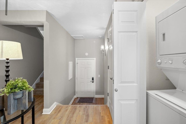 1702 Lakeshore Dr Unit 3, Lake City, MN 55041 - entrance foyer with stacked washer / dryer, light wood-style floors, and stairway