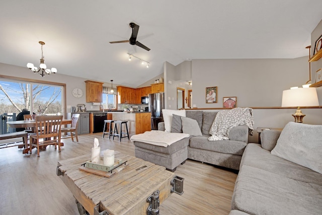1105 Pioneer Trl SE, Cambridge, MN 55008 - living room with lofted ceiling, a chandelier, a ceiling fan, and light wood-style floors
