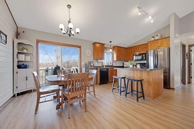 1105 Pioneer Trl SE, Cambridge, MN 55008 - dining area with a chandelier, light wood-style flooring, lofted ceiling, and plenty of natural light