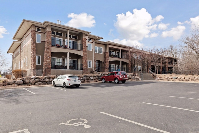 10806 Shore Dr Unit 103, Plymouth, MN 55441 - view of building exterior featuring uncovered parking