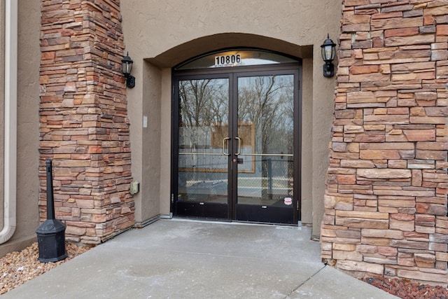 10806 Shore Dr Unit 103, Plymouth, MN 55441 - property entrance with french doors, stucco siding, and stone siding