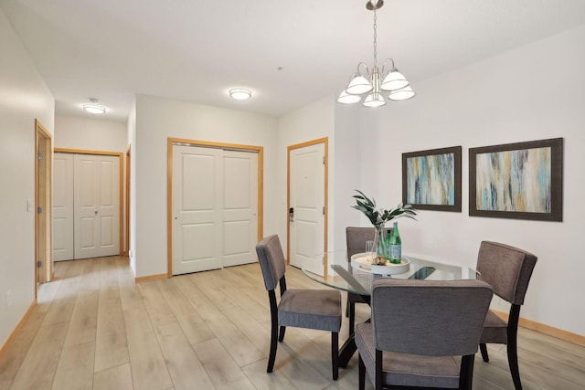10806 Shore Dr Unit 103, Plymouth, MN 55441 - dining area with a chandelier and light wood-style flooring
