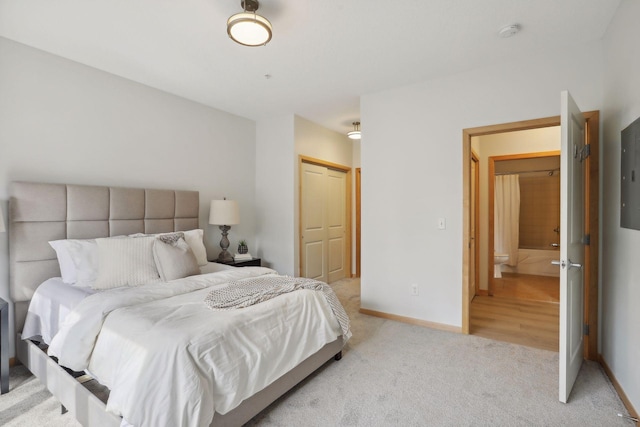 10806 Shore Dr Unit 103, Plymouth, MN 55441 - bedroom with light carpet, a closet, and ensuite bath