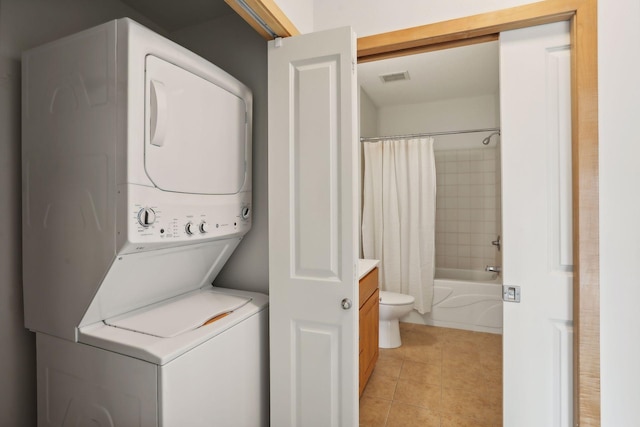 10806 Shore Dr Unit 103, Plymouth, MN 55441 - laundry room with stacked washing machine and dryer and light tile patterned floors