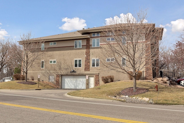 10806 Shore Dr Unit 103, Plymouth, MN 55441 - view of property with an attached garage and driveway