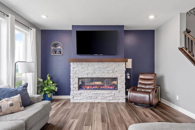1401 142nd Ct E, Rosemount, MN 55068 - living area featuring wood finished floors, baseboards, a fireplace, stairway, and recessed lighting