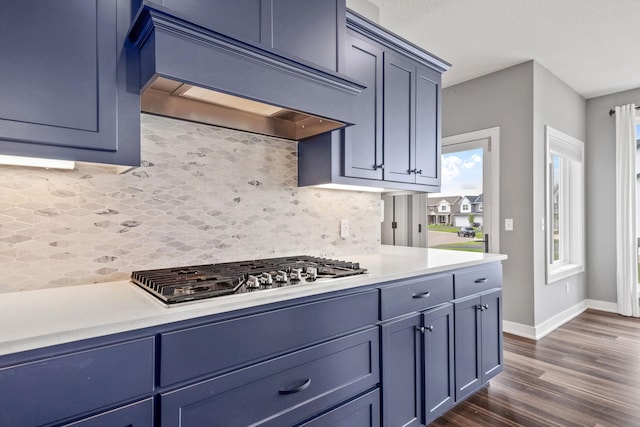 1401 142nd Ct E, Rosemount, MN 55068 - kitchen with custom exhaust hood, stainless steel gas cooktop, light countertops, dark wood-style floors, and baseboards
