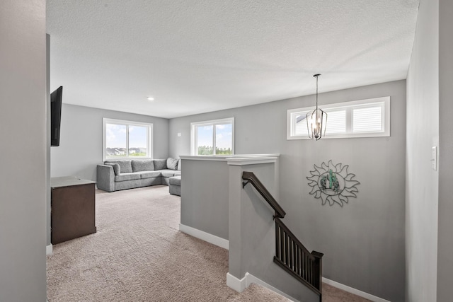 1401 142nd Ct E, Rosemount, MN 55068 - hallway with an upstairs landing, plenty of natural light, carpet floors, and a textured ceiling