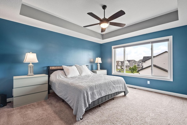1401 142nd Ct E, Rosemount, MN 55068 - bedroom with a tray ceiling, carpet, baseboards, and a ceiling fan