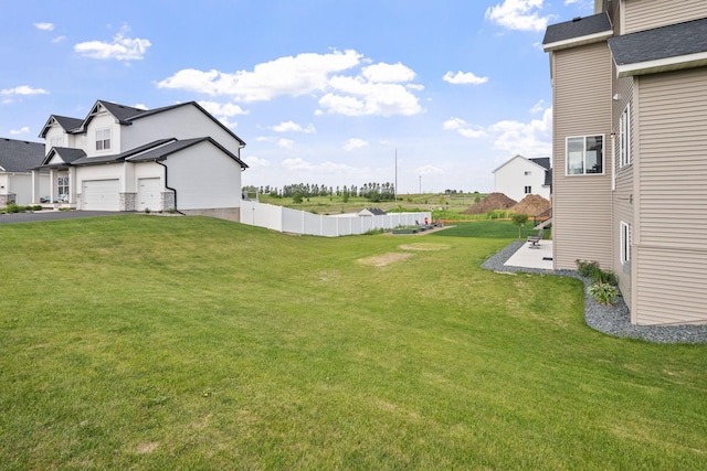 1401 142nd Ct E, Rosemount, MN 55068 - view of yard featuring a garage, driveway, and a patio area