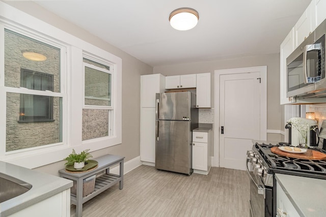 1848 James Ave, Saint Paul, MN 55105 - kitchen with stainless steel appliances, white cabinets, and light wood-style flooring