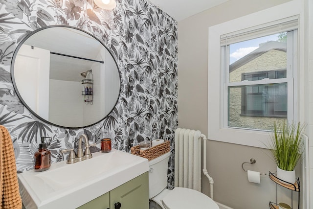 1848 James Ave, Saint Paul, MN 55105 - bathroom with radiator heating unit, wallpapered walls, vanity, and an accent wall