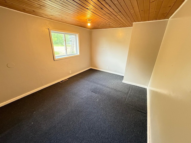 110 9th Ave NE, Deer River, MN 56636 - empty room with wooden ceiling, dark colored carpet, and baseboards