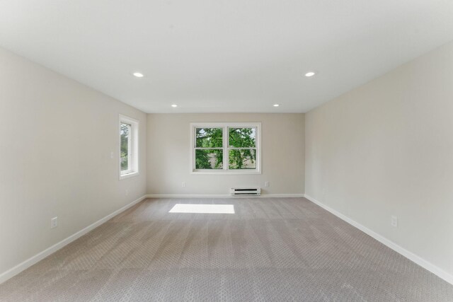 1032 Scheffer Ave, Saint Paul, MN 55102 - unfurnished room with light carpet, baseboards, recessed lighting, and baseboard heating