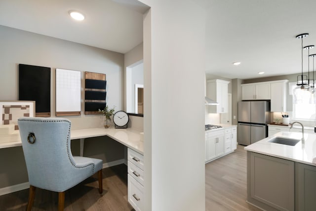 19648 104th Pl, Corcoran, MN 55374 - home office featuring a sink, light wood-style flooring, built in desk, and recessed lighting