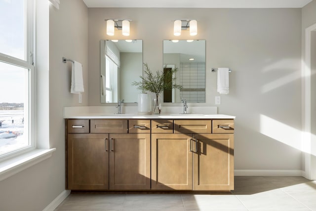 19648 104th Pl, Corcoran, MN 55374 - bathroom with double vanity, baseboards, tile patterned flooring, and tiled shower