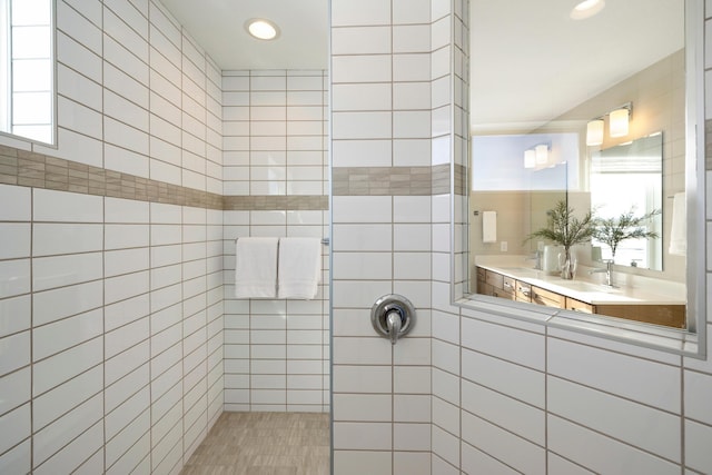19648 104th Pl, Corcoran, MN 55374 - bathroom with tiled shower, vanity, tile walls, and recessed lighting