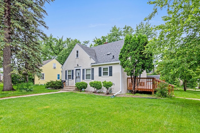 148 5th Ave N, Hopkins, MN 55343 - view of front of property featuring a shingled roof, a front lawn, a deck, and stucco siding