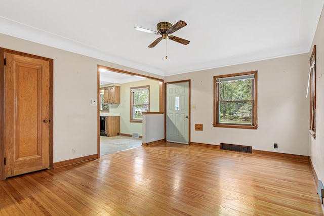 148 5th Ave N, Hopkins, MN 55343 - empty room featuring plenty of natural light, light wood finished floors, ceiling fan, and crown molding