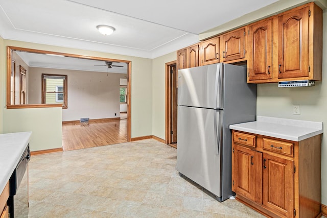 148 5th Ave N, Hopkins, MN 55343 - kitchen featuring freestanding refrigerator, brown cabinetry, light countertops, and ceiling fan