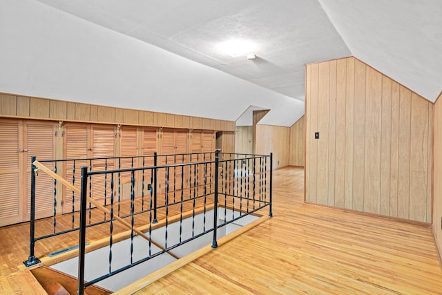 148 5th Ave N, Hopkins, MN 55343 - additional living space with wood finished floors, vaulted ceiling, and wood walls