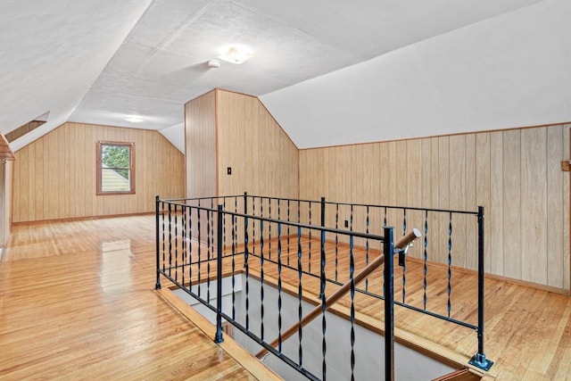 148 5th Ave N, Hopkins, MN 55343 - additional living space featuring wood finished floors, wood walls, and vaulted ceiling