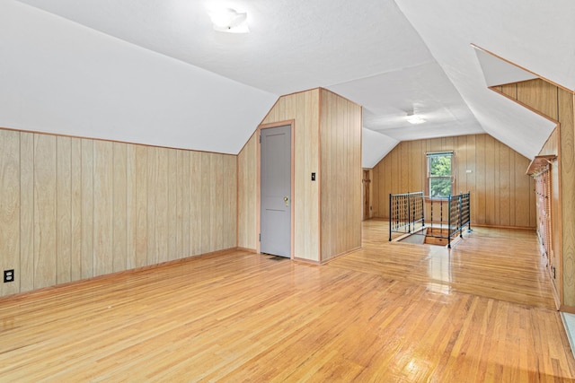 148 5th Ave N, Hopkins, MN 55343 - bonus room with wood finished floors, lofted ceiling, and wood walls