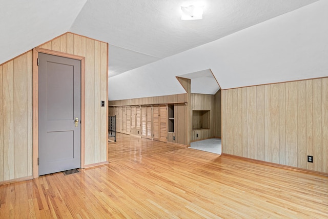 148 5th Ave N, Hopkins, MN 55343 - bonus room featuring wooden walls, wood finished floors, and lofted ceiling