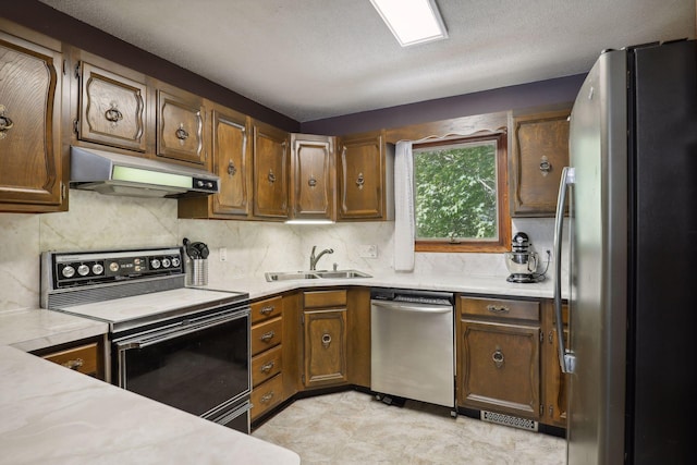 1060 Greer Ave NW, Albion Twp, MN 55358 - kitchen featuring appliances with stainless steel finishes, a sink, extractor fan, and light countertops