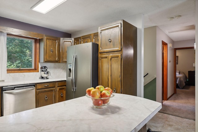 1060 Greer Ave NW, Albion Twp, MN 55358 - kitchen with stainless steel appliances, light countertops, and brown cabinets