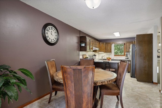 1060 Greer Ave NW, Albion Twp, MN 55358 - dining area featuring a textured ceiling and baseboards