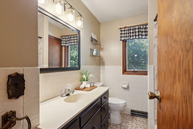 1060 Greer Ave NW, Albion Twp, MN 55358 - full bath with tile walls, toilet, vanity, wainscoting, and tile patterned floors