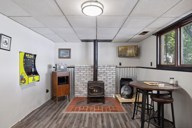 1060 Greer Ave NW, Albion Twp, MN 55358 - living room with wood finished floors, a wood stove, and a drop ceiling