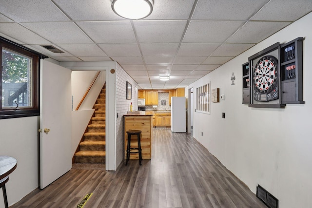 1060 Greer Ave NW, Albion Twp, MN 55358 - bar featuring white appliances, a paneled ceiling, wood finished floors, and stairway