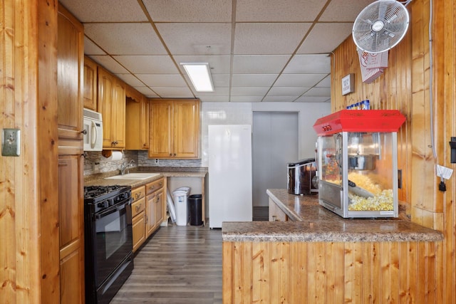 1060 Greer Ave NW, Albion Twp, MN 55358 - kitchen with black gas range oven, white microwave, a drop ceiling, dark wood-style floors, and backsplash