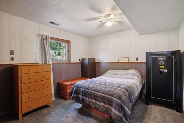 1060 Greer Ave NW, Albion Twp, MN 55358 - bedroom featuring carpet floors, wood walls, a textured ceiling, and a ceiling fan