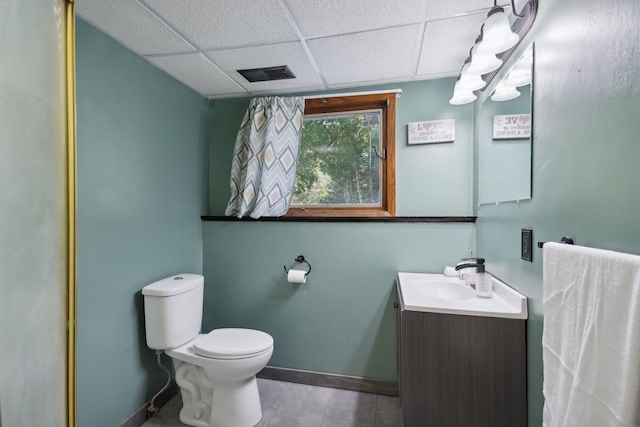 1060 Greer Ave NW, Albion Twp, MN 55358 - bathroom featuring a paneled ceiling, vanity, toilet, and baseboards