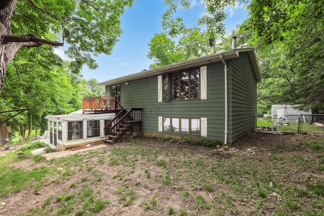 1060 Greer Ave NW, Albion Twp, MN 55358 - rear view of house with a sunroom, stairway, and a deck
