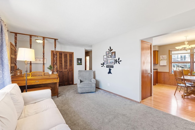 3513 Adair Ave N, Crystal, MN 55422 - living area featuring a chandelier, a wainscoted wall, light colored carpet, and wooden walls