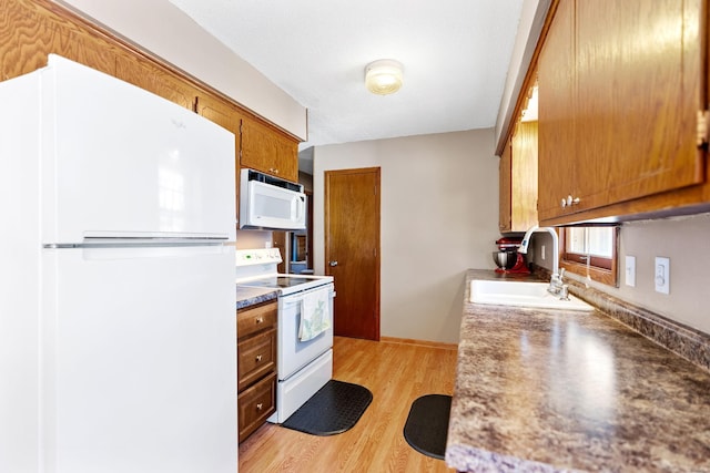 3513 Adair Ave N, Crystal, MN 55422 - kitchen with white appliances, a sink, brown cabinetry, and light wood-style flooring
