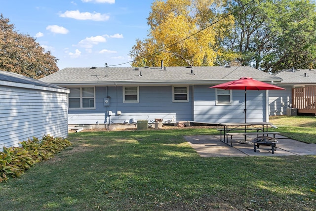 3513 Adair Ave N, Crystal, MN 55422 - back of house with a fire pit, a patio, a yard, roof with shingles, and central AC